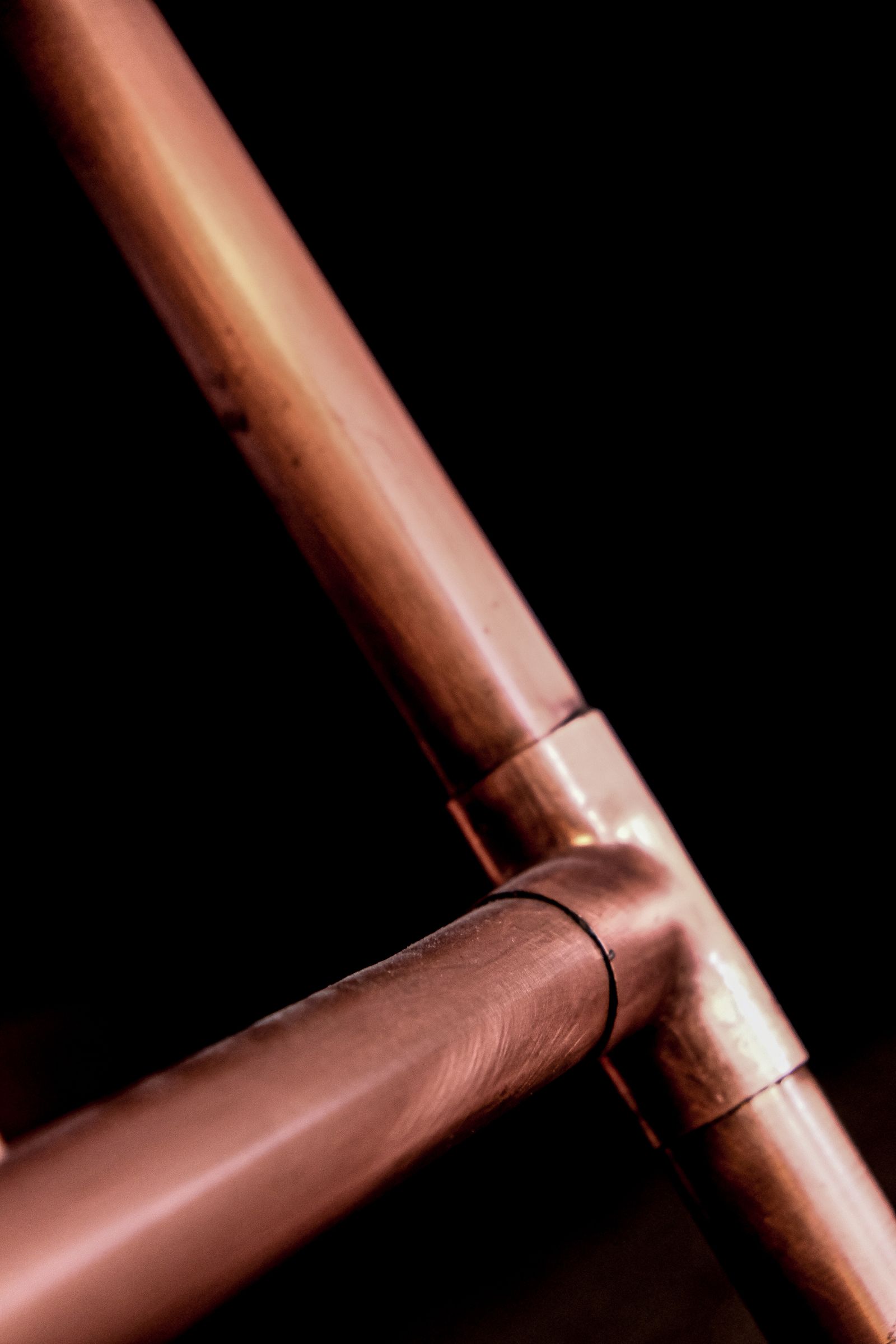 Copper supply lines against a dark background